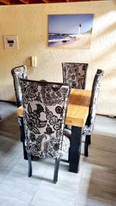 a wooden table with two chairs and a picture of a lighthouse at Merry Monte Casino Lodge House in Fourways in Sandton