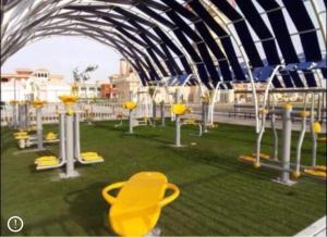 een speeltuin met gele stoelen op het gras bij Apartment in Porto sharm in Sharm El Sheikh