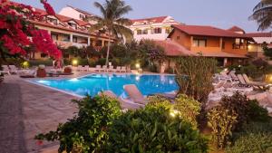 a resort with a swimming pool and lounge chairs at Porto Antigo 2 BeachFront in Santa Maria