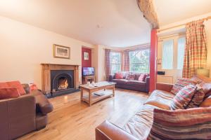 a living room with a couch and a fireplace at 1 Dixon Ground Coniston in Coniston