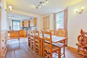 a kitchen and dining room with a wooden table and chairs at 1 Dixon Ground Coniston in Coniston