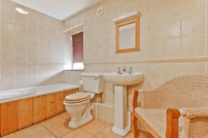 a bathroom with a toilet and a sink and a bath tub at 1 Dixon Ground Coniston in Coniston