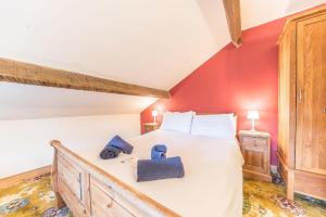 a bedroom with a large bed with red walls at 1 Dixon Ground Coniston in Coniston