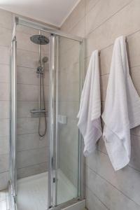 a bathroom with a shower with towels on the wall at Tantul Crissol 211 Apto 1Hab in Los Cristianos