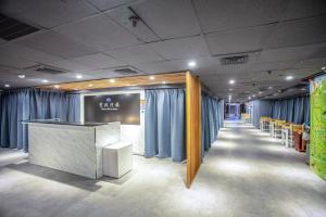 a room with blue curtains and a long corridor at 雲沐行旅 Hotel Cloud Arena-Daan in Taipei