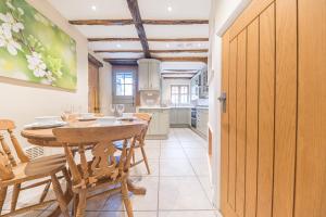 a kitchen and dining room with a table and chairs at 2 Dixon Ground Coniston in Coniston