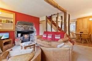 a living room with two couches and a fireplace at 4 Dixon Ground Coniston in Coniston