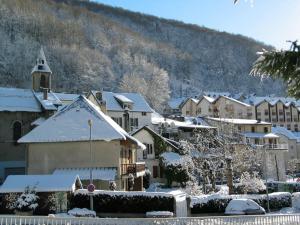 a town with snow covered buildings and a church at Boost Your Immo Barèges Artigalas PM55 in Barèges