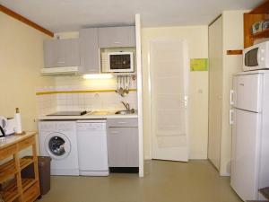 a kitchen with white appliances and a washer and dryer at Boost Your Immo Barèges Artigalas PM55 in Barèges