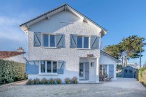 a white house with blue shutters on it at Belle maison pour 11 - Jardin - Détente in La Baule