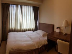 Postel nebo postele na pokoji v ubytování AJ Residence 安捷國際公寓酒店