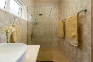 a bathroom with a shower and a toilet and a sink at TOP VIEW RETREAT SELFCATERING in Anse a La Mouche