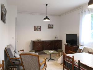 a living room with a table and a tv at Maison Villard-de-Lans, 4 pièces, 8 personnes - FR-1-548-5 in Villard-de-Lans