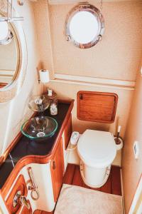 a small bathroom with a toilet and a sink at The Opportunity to Live on a sailing yacht in Bodrum Marina in Bodrum City