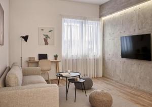 a living room with a couch and a tv at Cute n Comfort Luxury Condo in Kolonaki in Athens