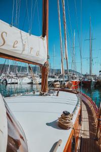 a sailboat docked in a harbor with other boats at The Opportunity to Live on a sailing yacht in Bodrum Marina in Bodrum City