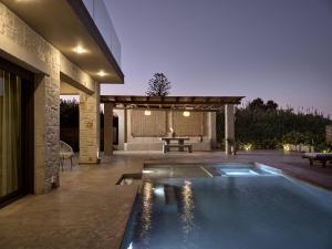 a swimming pool in the backyard of a house at LaTerre Villa, Zante Zen By ThinkVilla in Psarou