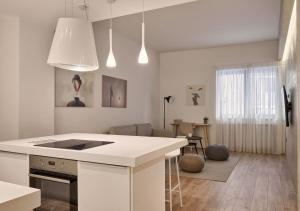 a kitchen with a white island in a room at Cute n Comfort Luxury Condo in Kolonaki in Athens
