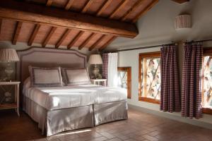 a bedroom with a large bed in a room at Relais Villa Olmo - Place of Charme in Impruneta +78 photos