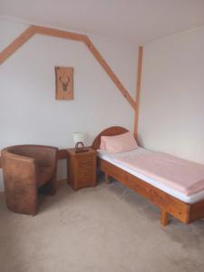 1 Schlafzimmer mit 2 Betten und einem Stuhl in der Unterkunft Wald-Landhaus in Hahnenklee-Bockswiese