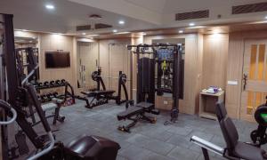 a room with a gym with several tread machines at The Greenwood Guwahati - A Luxury Boutique Hotel in Guwahati