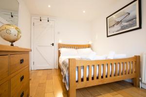 a bedroom with a bed with a wooden crib at The Old Bakery in Falmouth