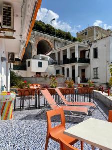 a patio with tables and chairs and a building at Bellavista Costa d'Amalfi in Vietri sul Mare