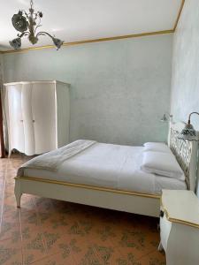 a bedroom with a bed with a blue wall at Bellavista Costa d'Amalfi in Vietri sul Mare