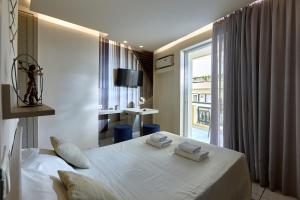 a hotel room with a bed and a window at Prime Room in Heraklion Center in Heraklio