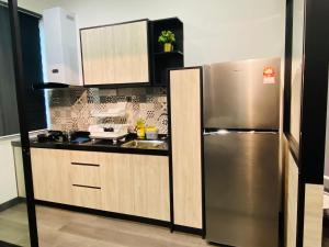 a kitchen with a stainless steel refrigerator at Vista Bangi Soho UKM, Swimming pool & River view in Kajang
