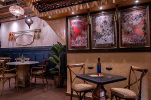 a restaurant with two tables and two glasses of wine at DECAN Concept Boutique Estate in Rhodes Town