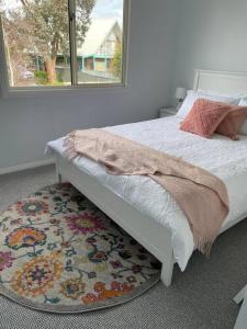 a bedroom with a bed with a rug and a window at McCracken Homestay in McCracken