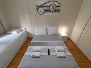 a bedroom with two beds and a picture of a car on the wall at Room Dream Beato in Lisbon