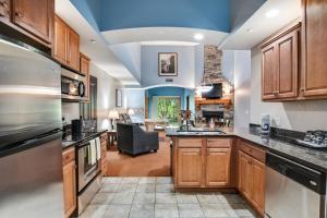 a kitchen with wooden cabinets and a living room at Chula Vista Condo Unit #2145 in Wisconsin Dells