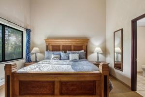 a bedroom with a large wooden bed with two lamps at Chula Vista Condo Unit #2145 in Wisconsin Dells