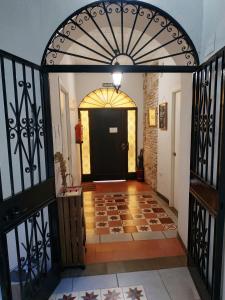 a hallway with a black door and a tile floor at Patio de Arance in Málaga