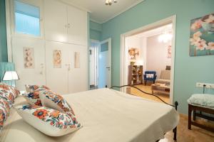a bedroom with a bed and a living room at Pasalimani 1 bedroom 4 persons apartment in Piraeus