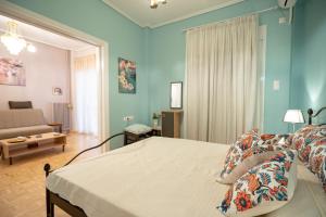 a bedroom with a bed and a living room at Pasalimani 1 bedroom 4 persons apartment in Piraeus
