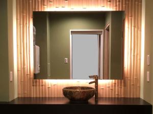 a bathroom with a sink and a large mirror at Osaka Ukiyoe Ryokan in Osaka