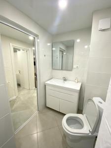 a bathroom with a toilet and a sink and a shower at GSS - B Apartment in Tbilisi City