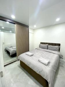 a bedroom with a large bed with two towels on it at GSS - B Apartment in Tbilisi City
