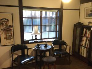 a room with a table and two chairs and a window at Machiya Tsubara Gojozaka - Vacation STAY 39192 in Kyoto