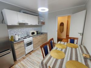 a kitchen and dining room with a table and chairs at Cozy apartment next to Paldiski harbor in Paldiski
