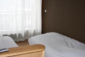 Postel nebo postele na pokoji v ubytování Accueil Savoyard
