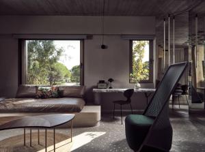 a living room with a couch and a table at Ekies All Senses Resort, a Member of Design Hotels in Vourvourou