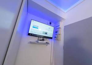 telewizor z płaskim ekranem na ścianie w pokoju w obiekcie Appart'Hôtel de la Gare - Cocooning w mieście Montbéliard