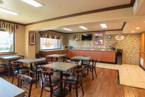 a restaurant with tables and chairs in a room at Super 8 by Wyndham Anaheim/Disneyland Drive in Anaheim