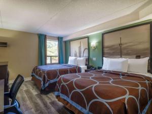 a hotel room with two beds and a window at Super 8 by Wyndham Toronto East ON in Toronto