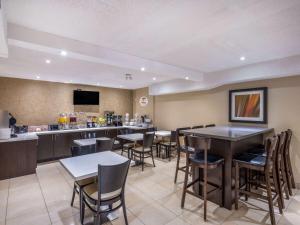 a restaurant with tables and chairs and a bar at Super 8 by Wyndham Toronto East ON in Toronto