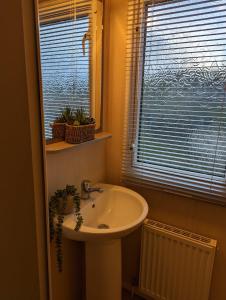 a bathroom with a sink and a window at Littlesea haven Rachel’s retreat in Wyke Regis